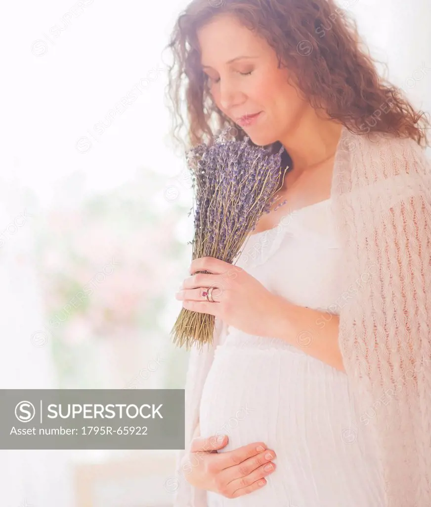 Portrait of pregnant woman with bunch of lavender