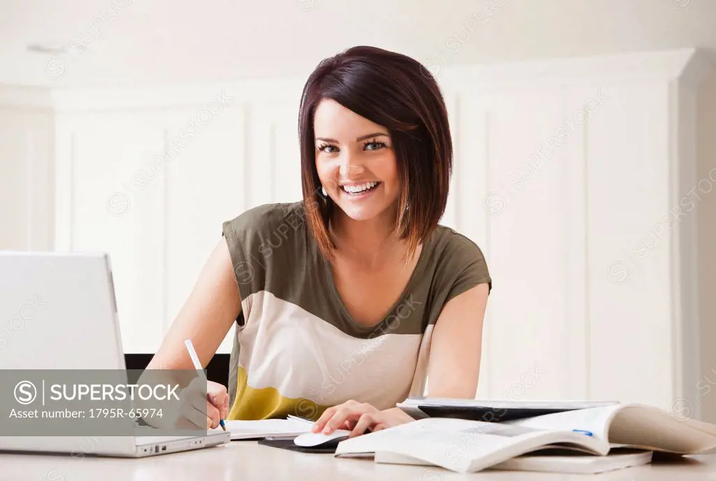 Portrait of young woman learning at home