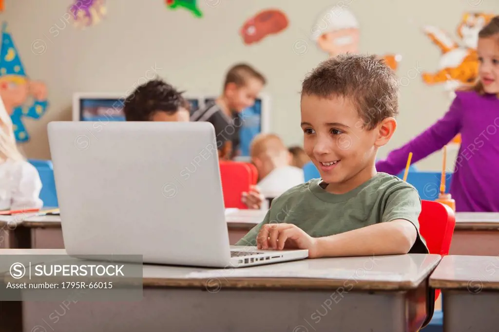 Children 4_5, 6_7 at school using laptop