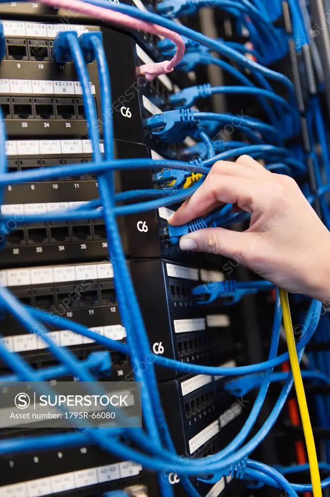 Close_up of female IT support technician repairing server
