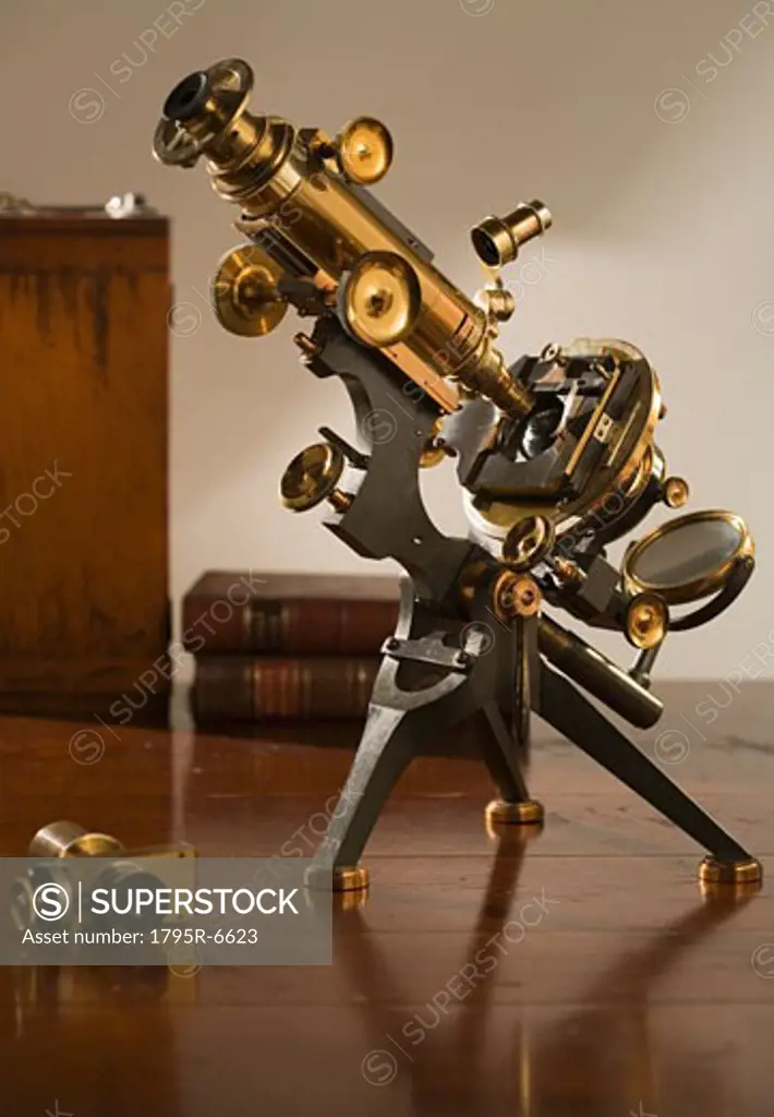 Old fashioned microscope on table