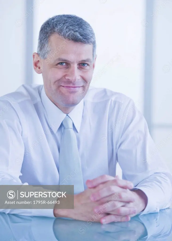 Portrait of businessman sitting at desk