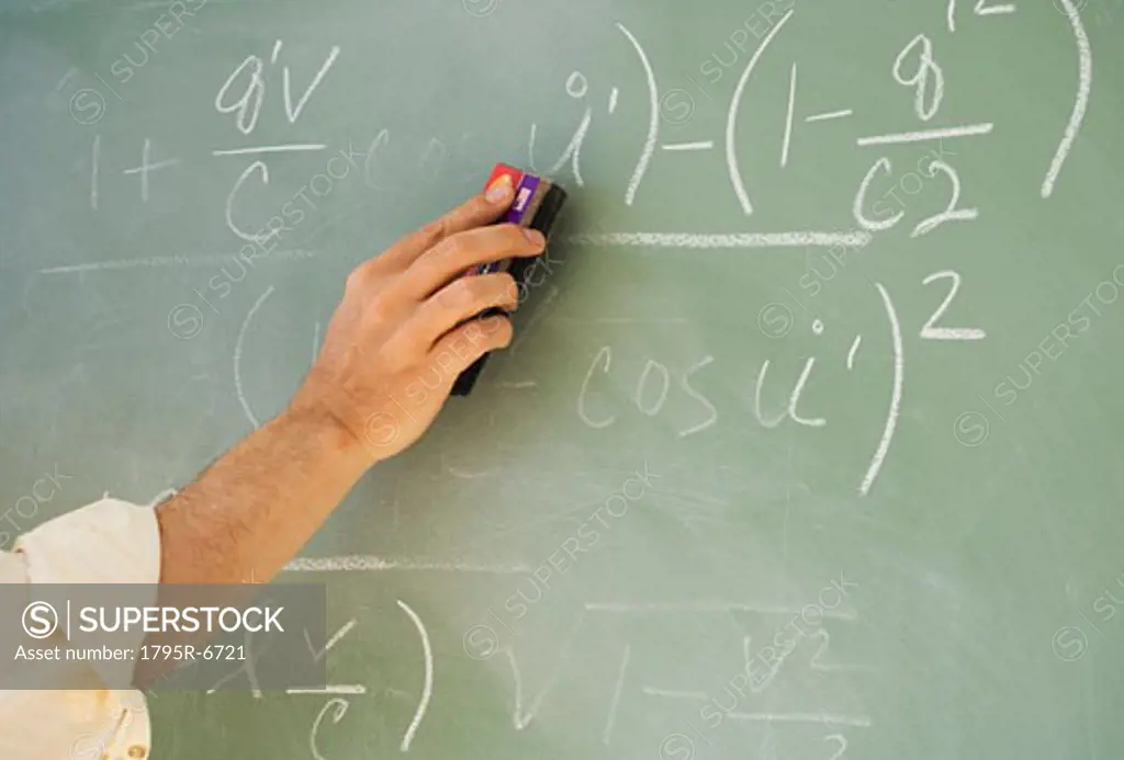 Professor erasing formulae on blackboard