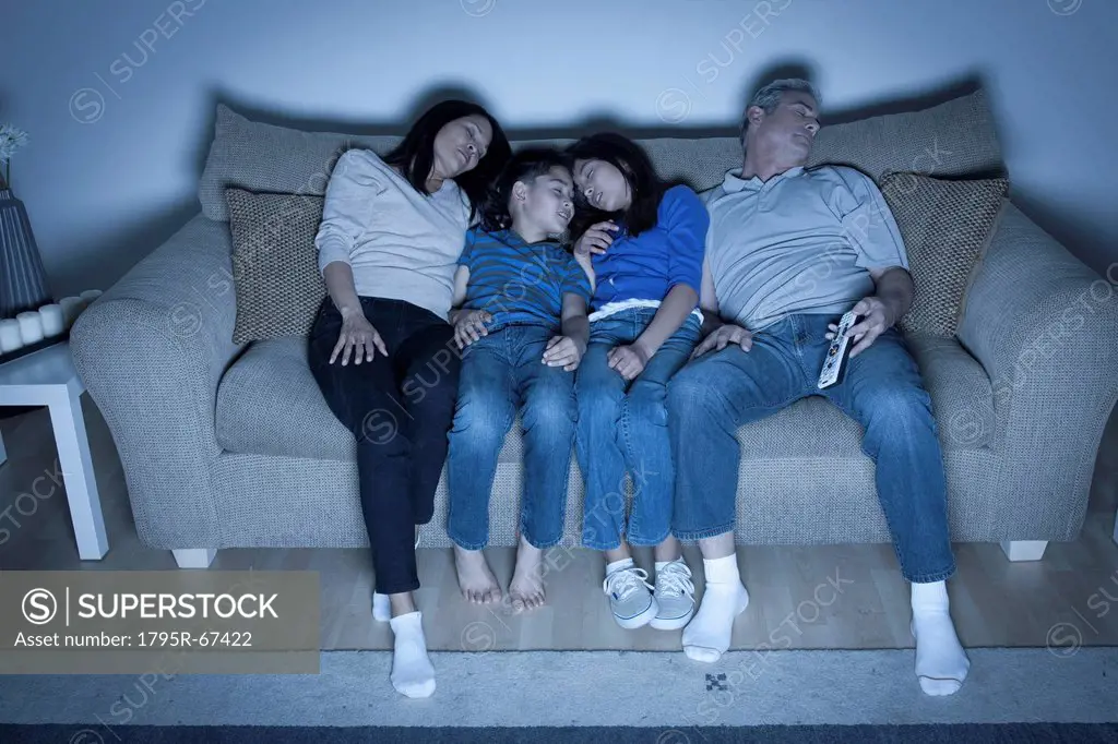 Family sitting on sofa sleeping