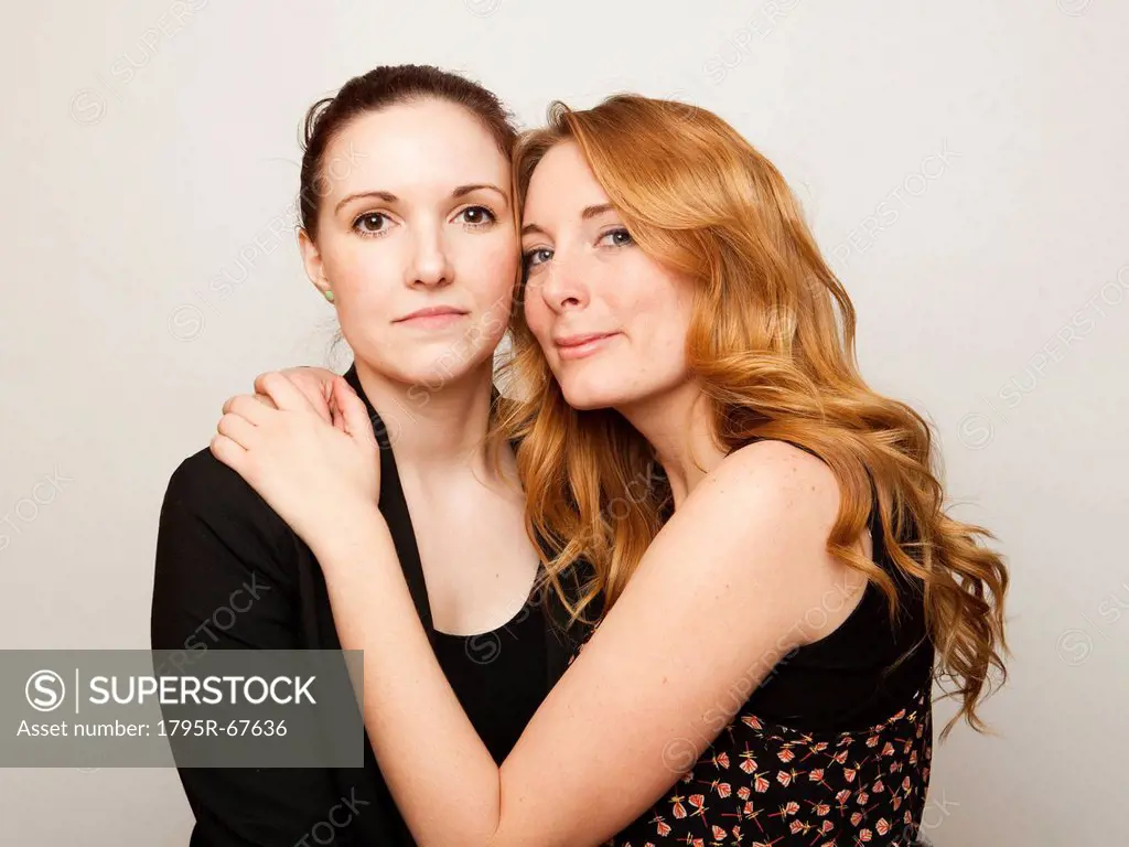 Studio Shot portrait of young women embracing