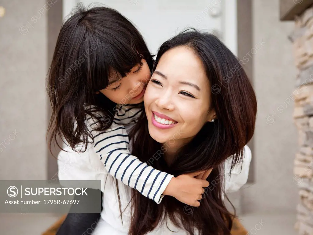 Smiling woman embracing by her daughter 4_5