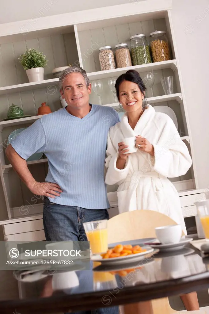 Couple standing over breakfast table
