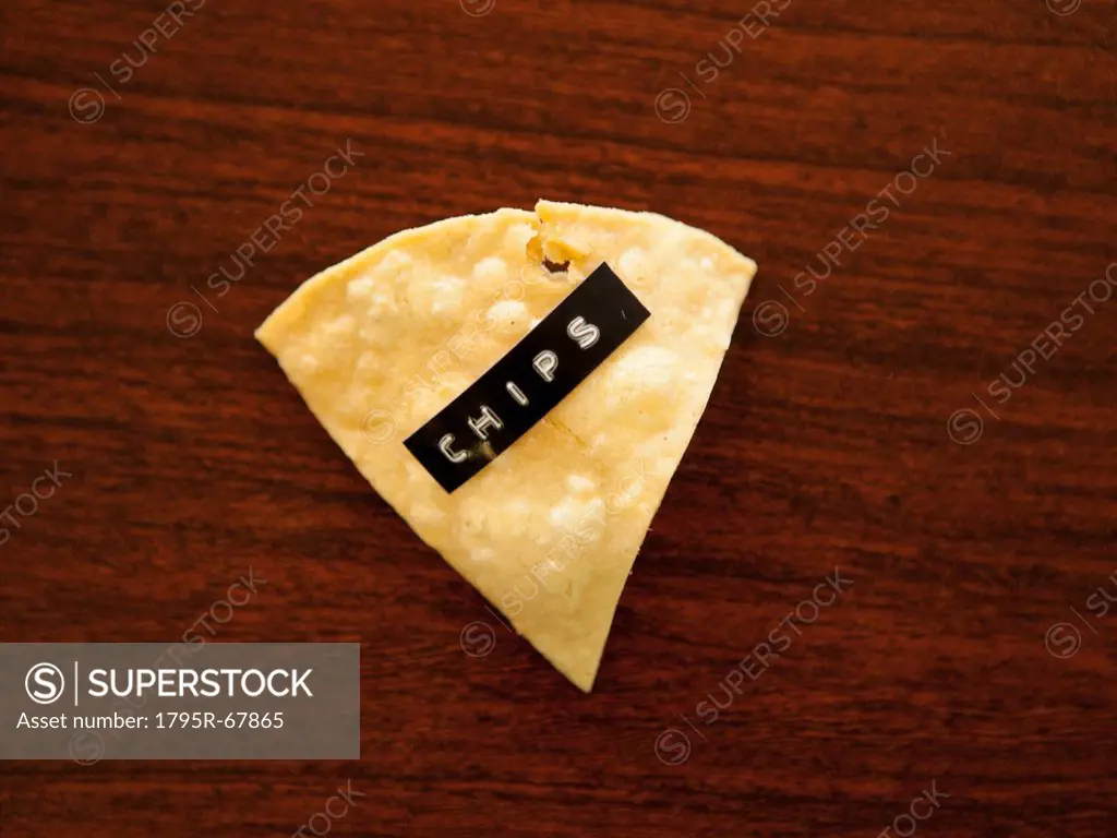 Close_up view of nacho chip with label reading chips