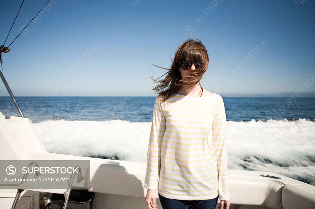 Portrait of young woman in sunglasses in front of sea