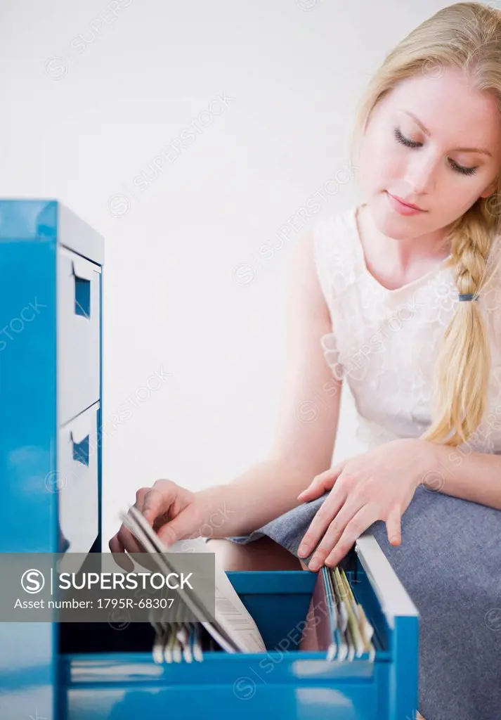 Woman looking into file cabinet