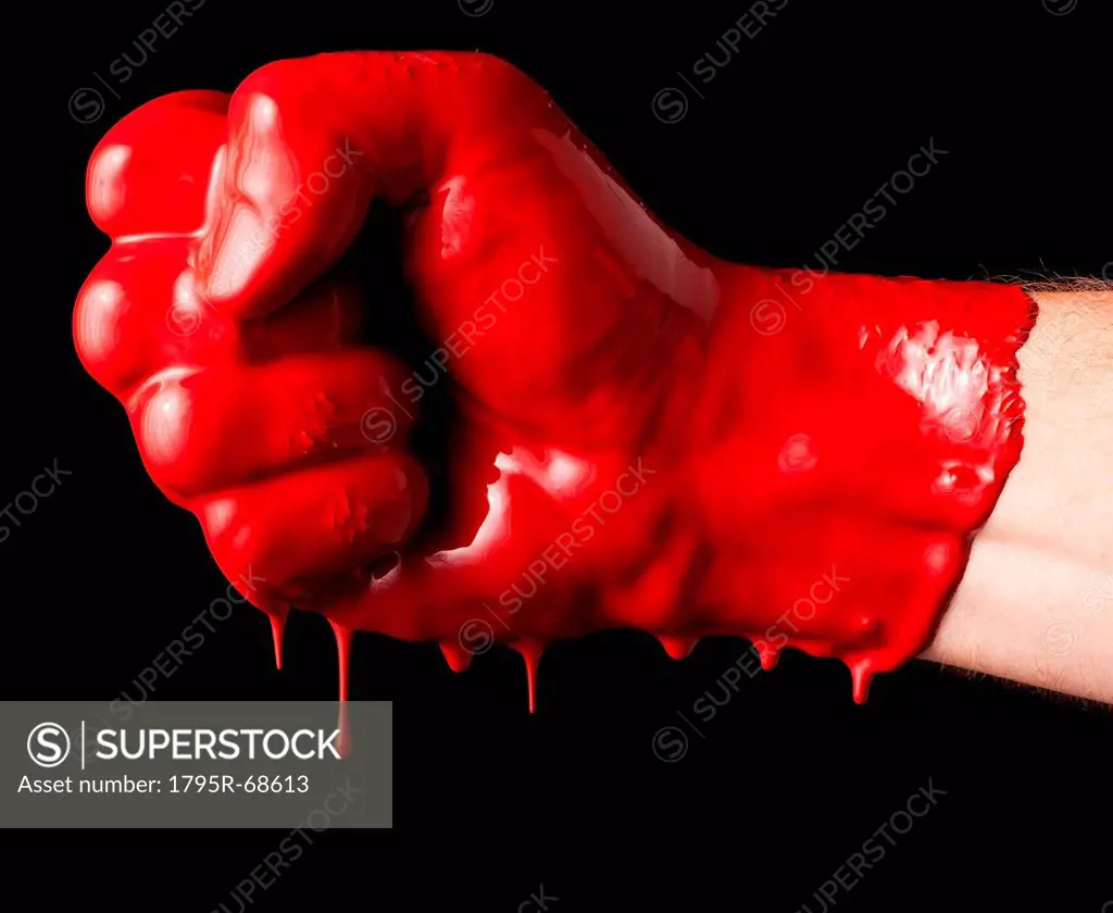 Human fist covered with red paint