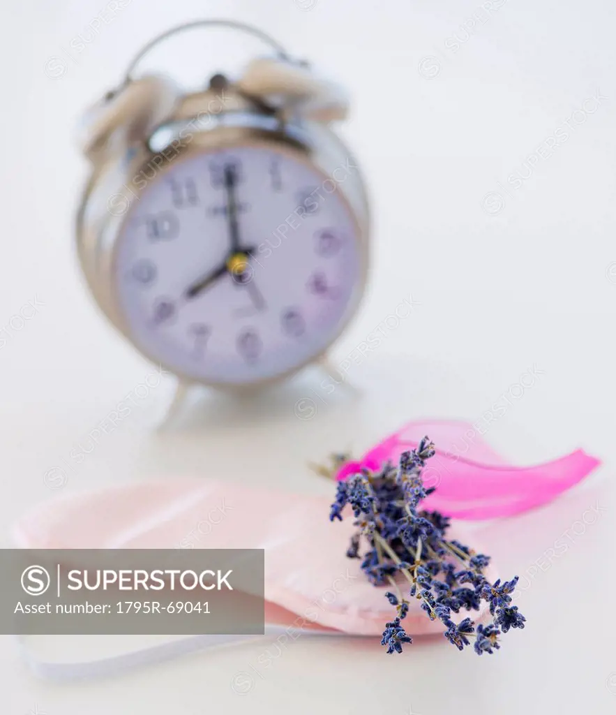 Close up of lavender, alarm clock and sleep masks, studio shot