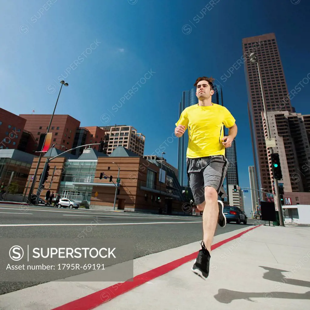 USA, California, Los Angeles, Young man running on city street