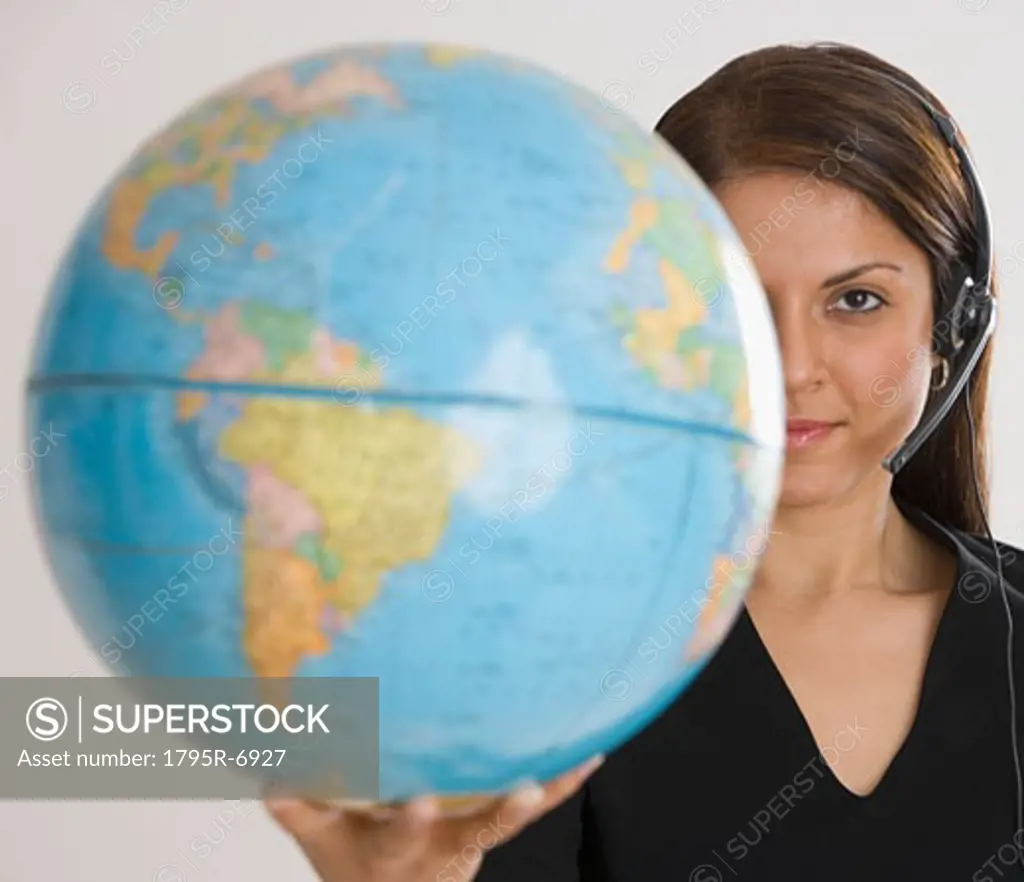 Indian businesswoman holding globe