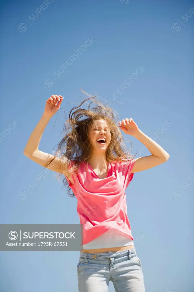 Happy woman jumping outdoors