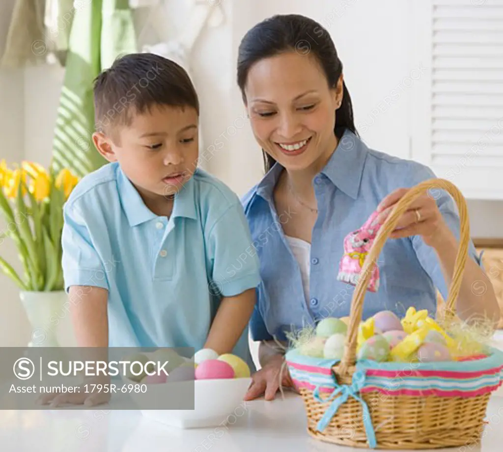 Asian mother and son making Easter basket