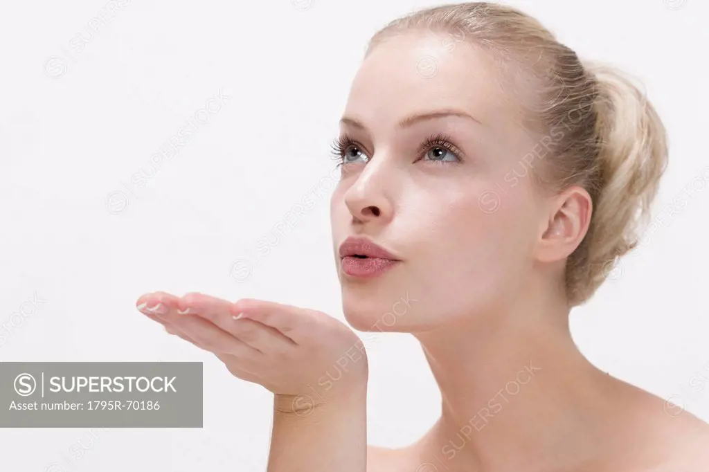 Beauty portrait of woman blowing kiss