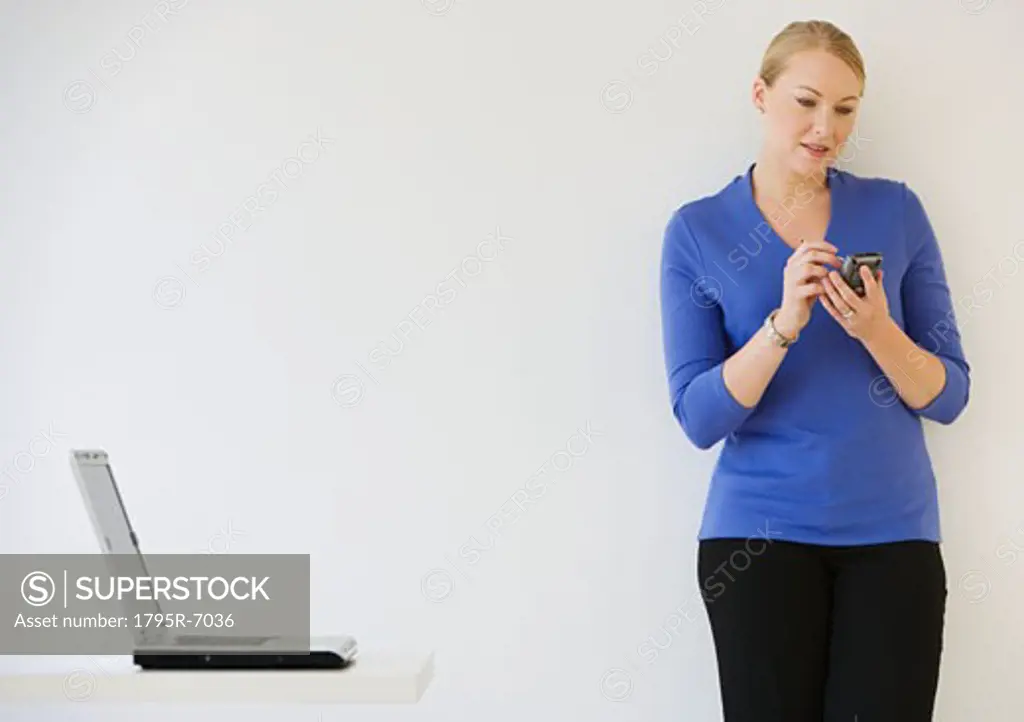 Businesswoman using electronic organizer