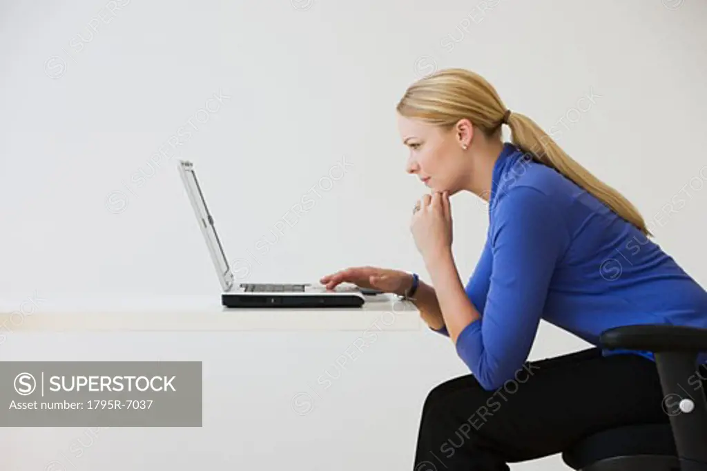 Businesswoman typing on laptop