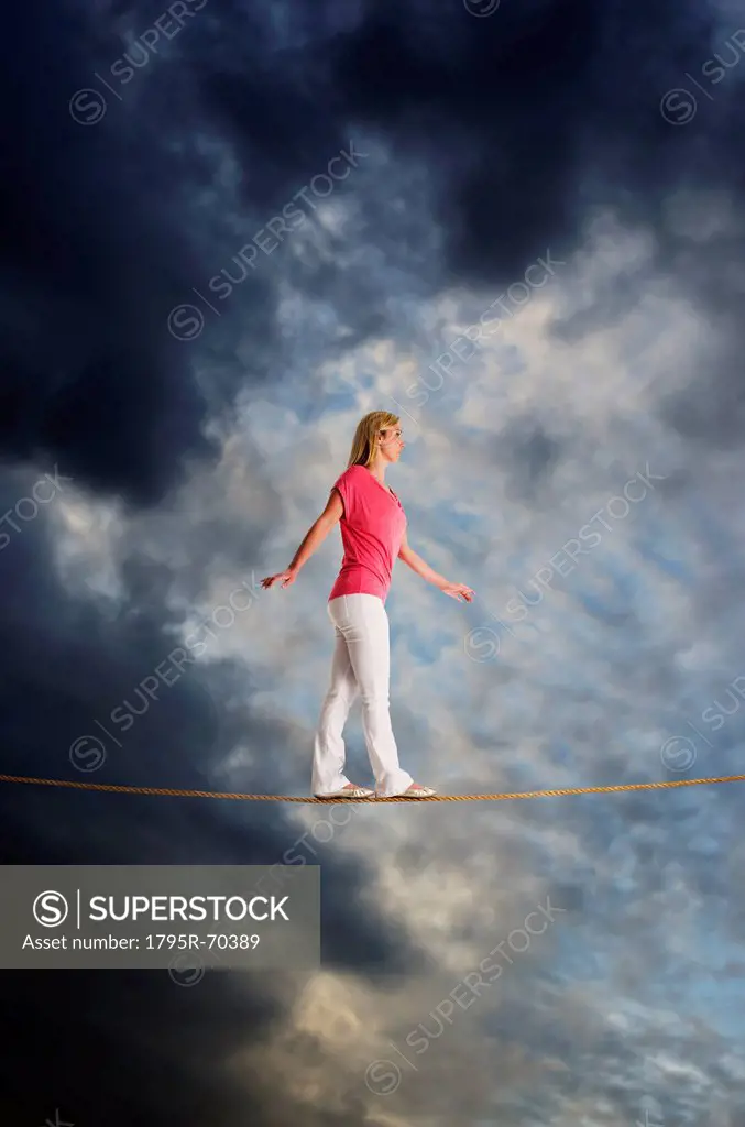 Woman walking on tightrope