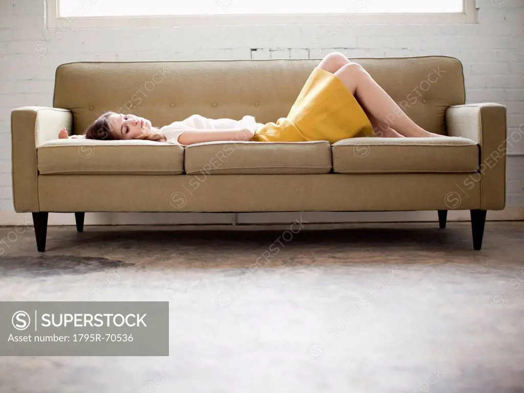 Young woman lying on sofa