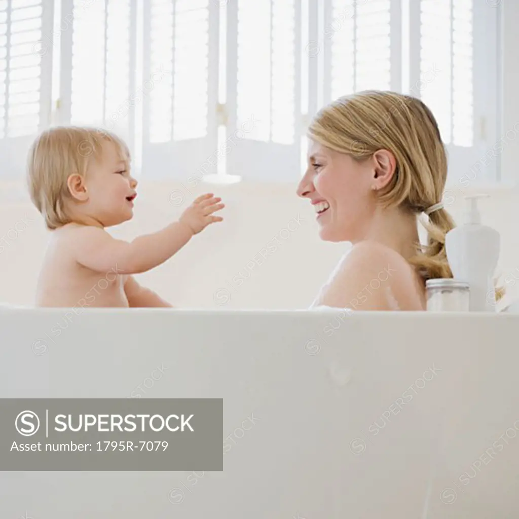 Mother and baby in bathtub