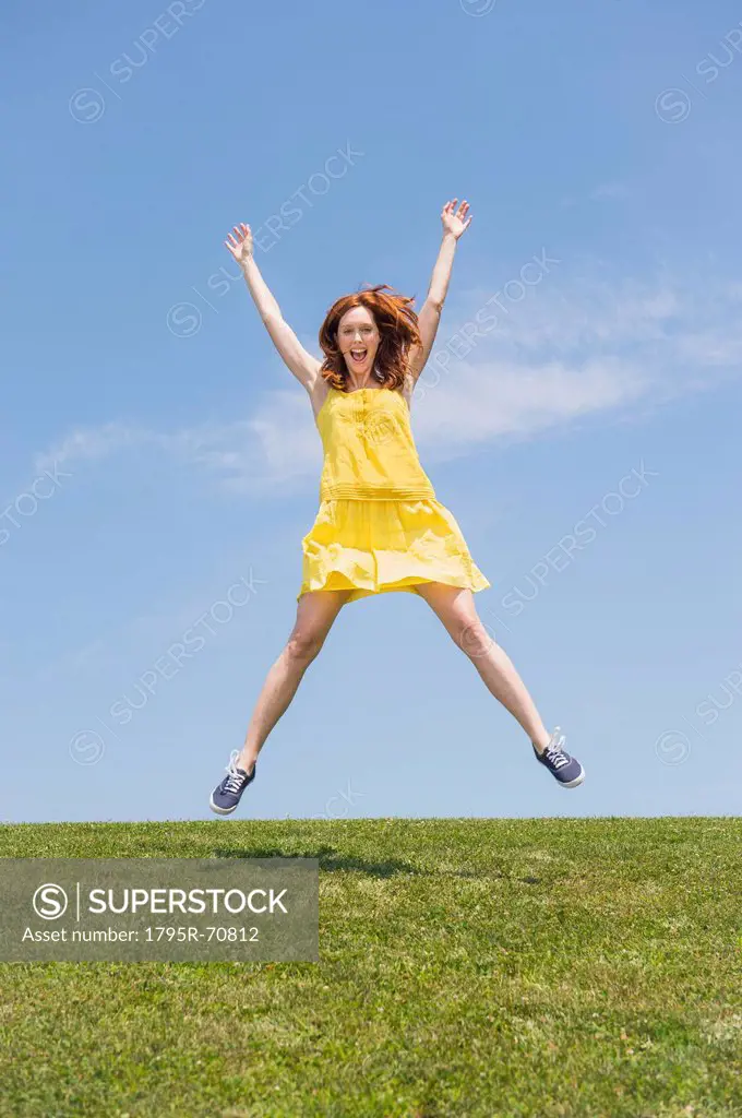 Woman jumping on meadow