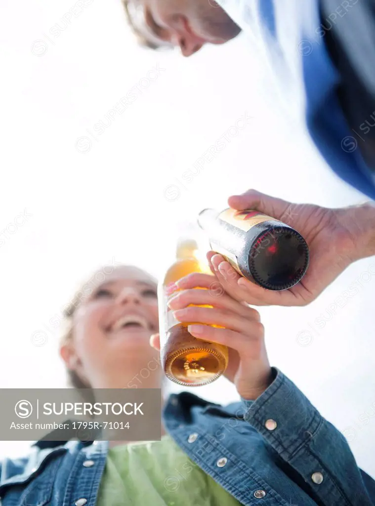 Happy young couple drinking beer