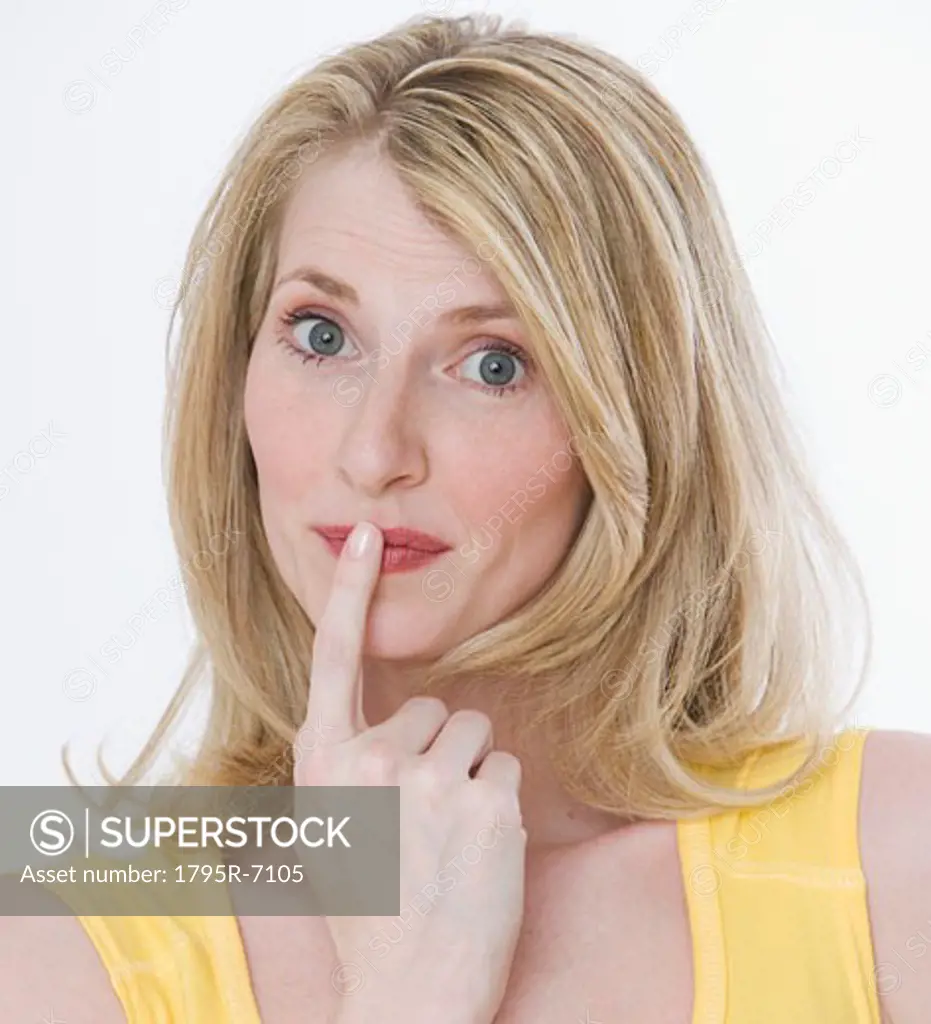 Woman with finger on mouth