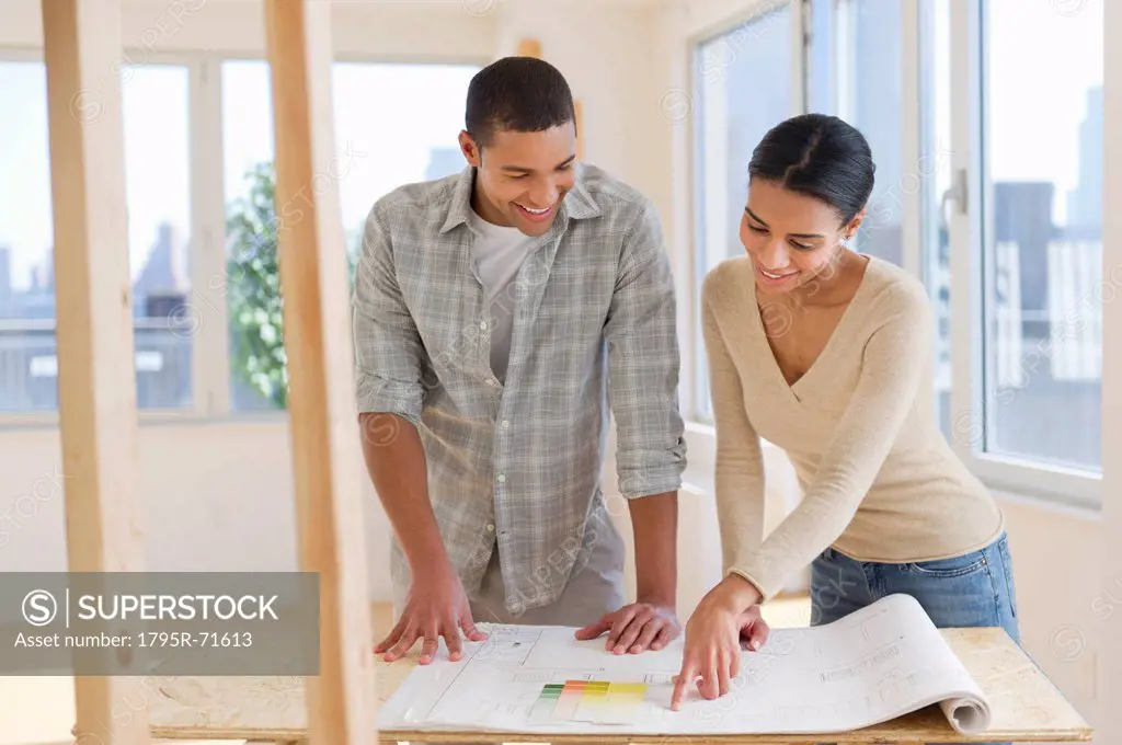 Couple looking at house blueprints