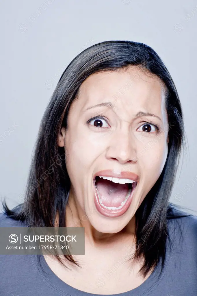 Portrait of screaming young woman, studio shot