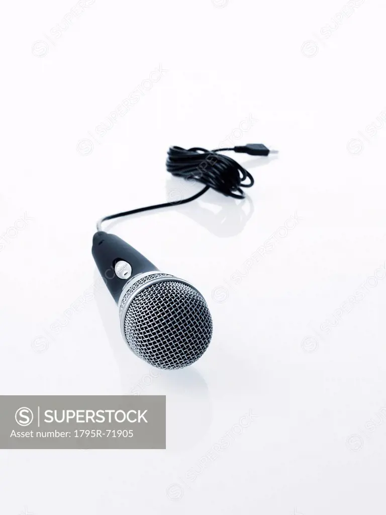 Studio shot of microphone and microphone cable on white background