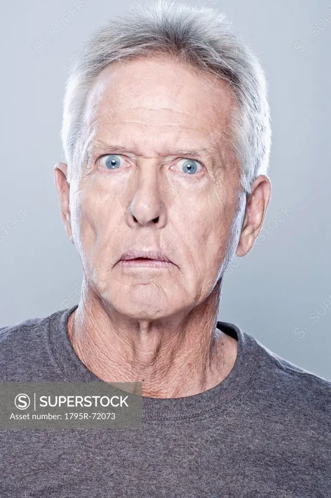 Portrait of shocked senior man, studio shot