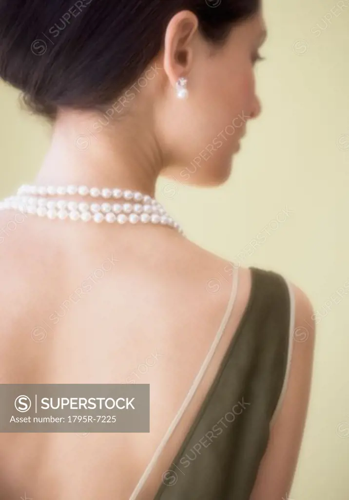 Rear view of woman wearing pearl necklace