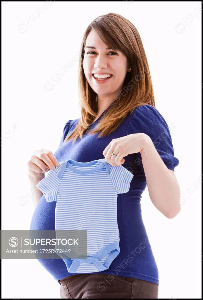 Studio Shot of woman holing baby blue onesie