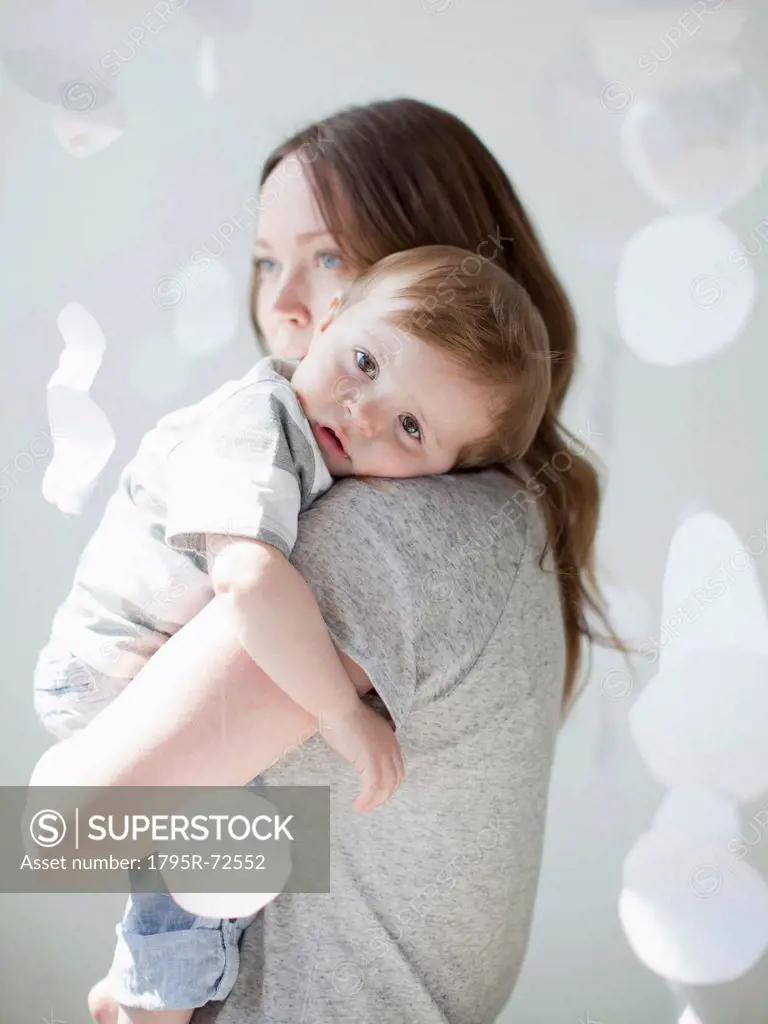 Portrait of serene young woman embracing baby boy 6_11 months