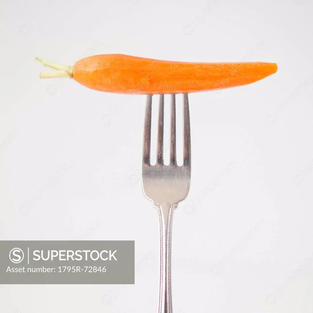 Carrot on fork, studio shot