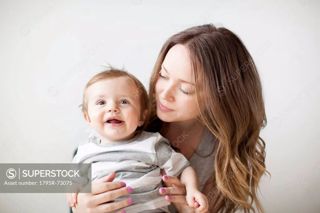 Portrait of young woman embracing baby boy 6_11 months