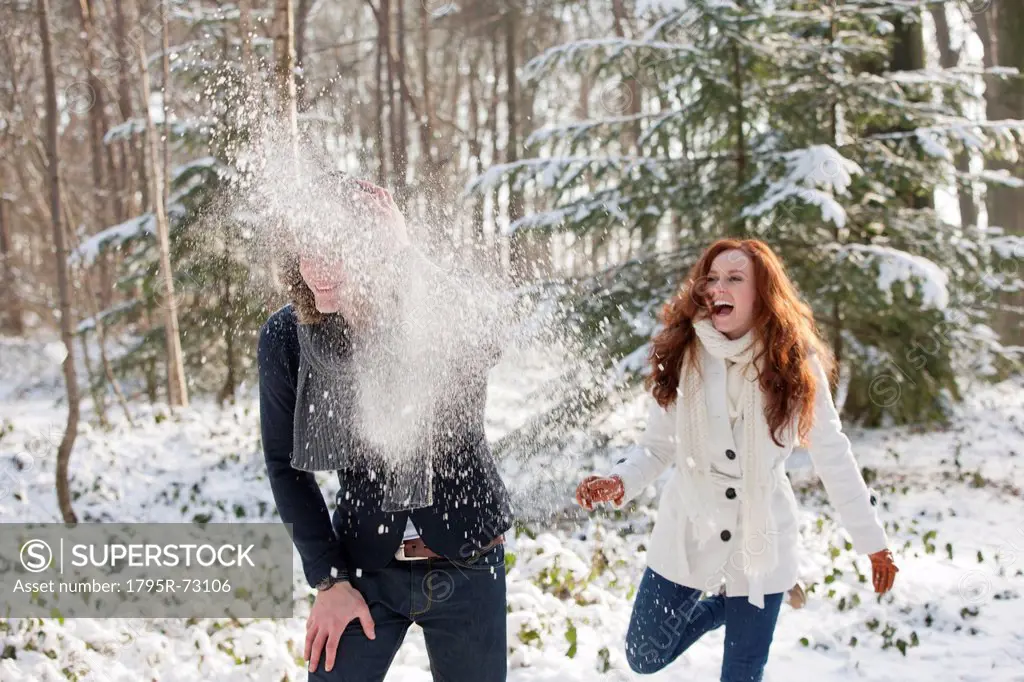 Young couple are having snowball fight