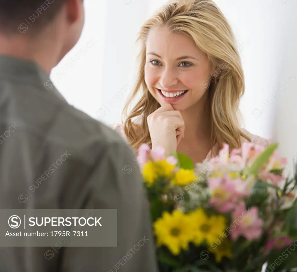 Woman receiving flowers from boyfriend