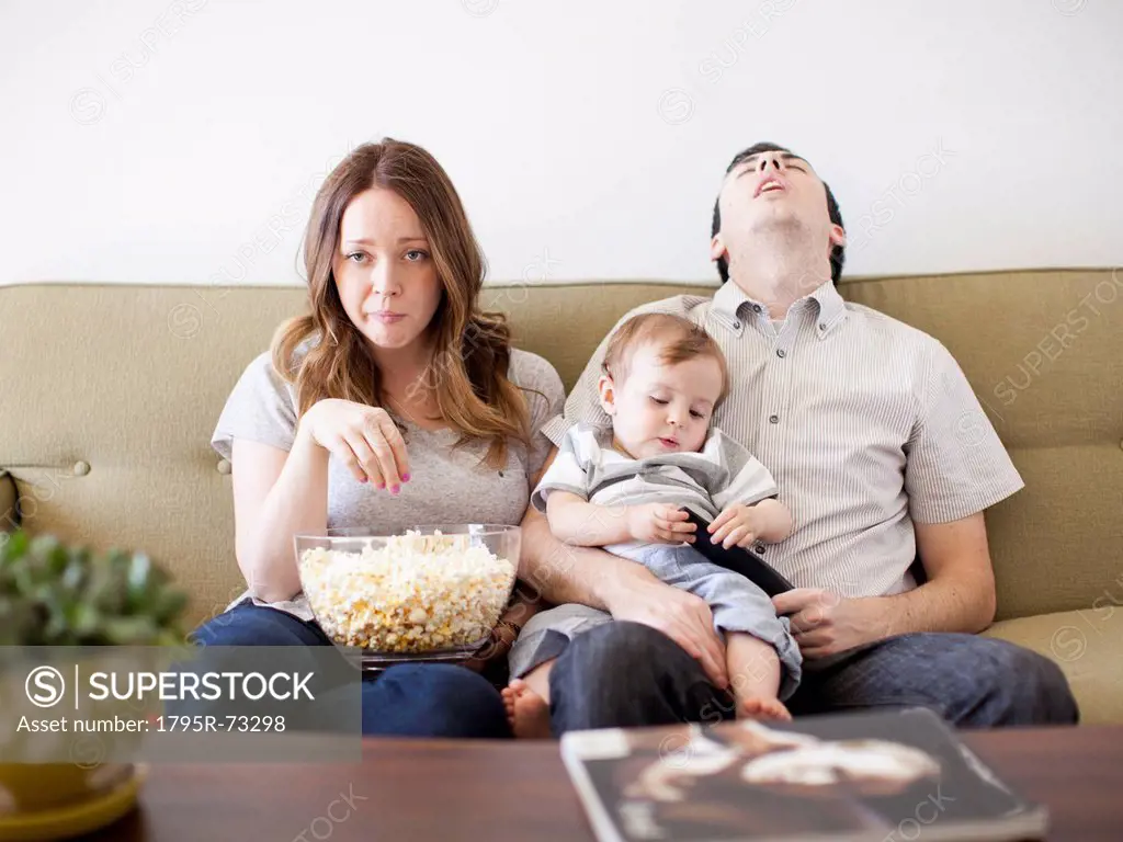 Young couple with baby boy 6_11 months watching TV