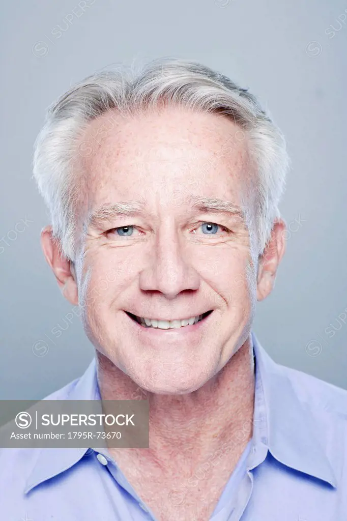 Portrait of smiling senior man, studio shot