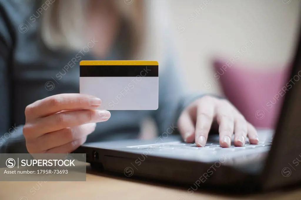 Netherlands, Goirle, Young woman shopping online