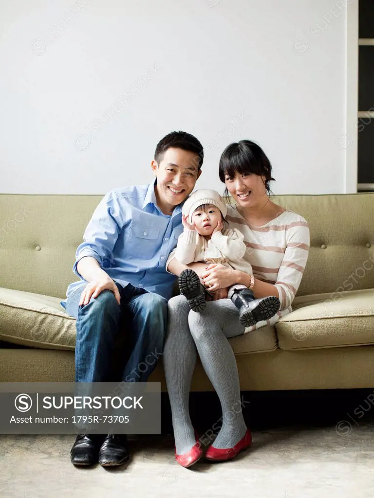 Portrait of young parents with baby girl 12_17 months