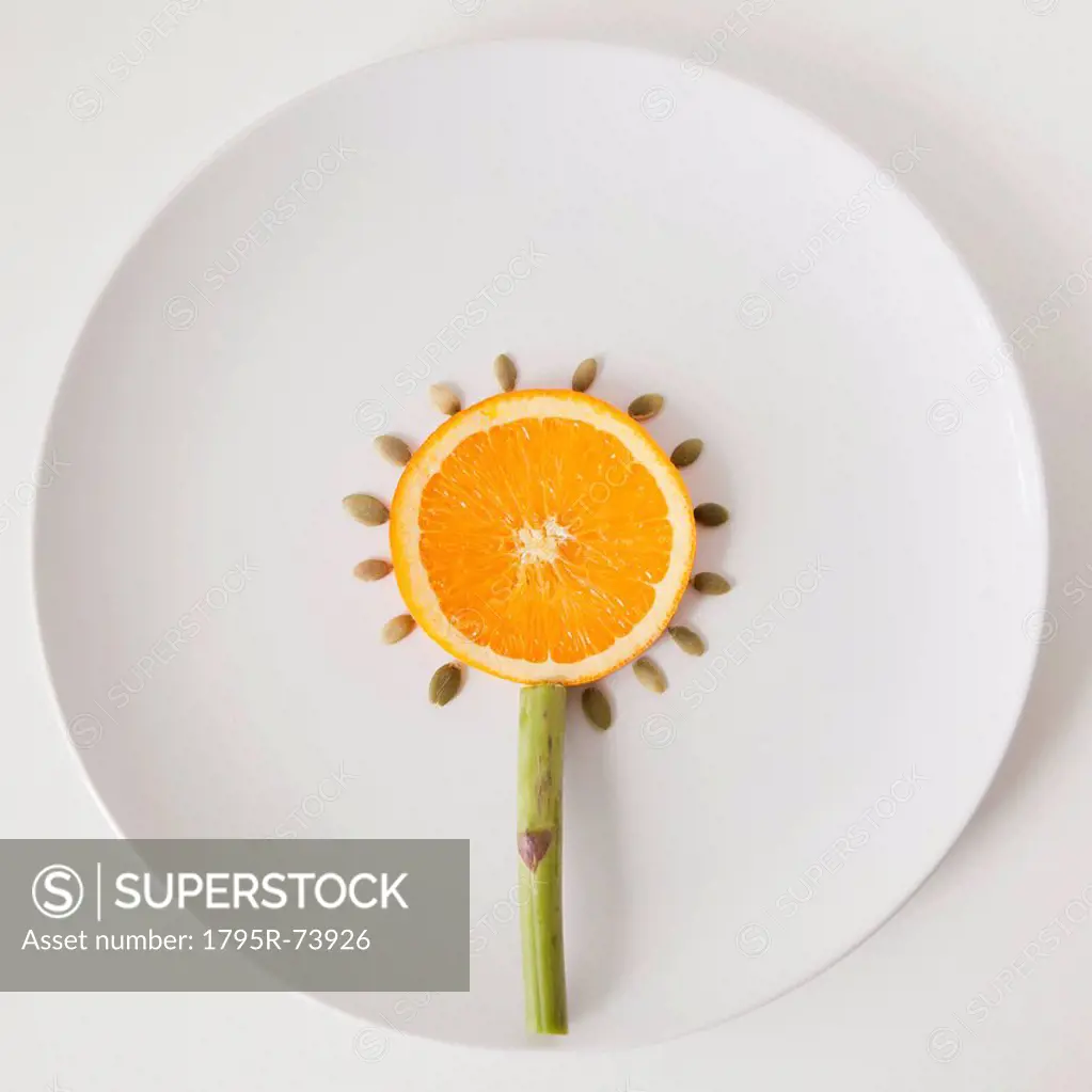 Sunflower made out of food on plate, studio shot