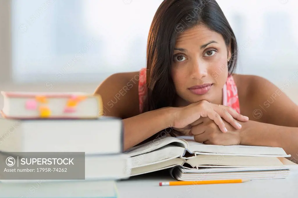 Female student leaning on books