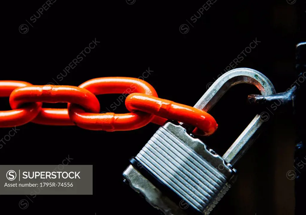 Chain with padlock on black background, studio shot