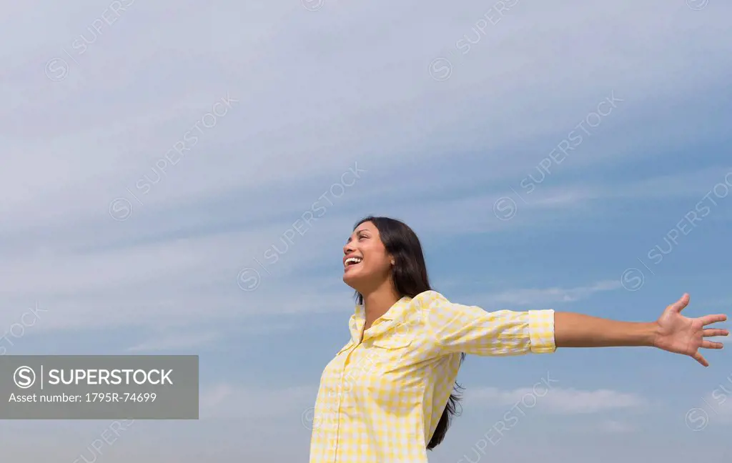 Happy woman against blue sky