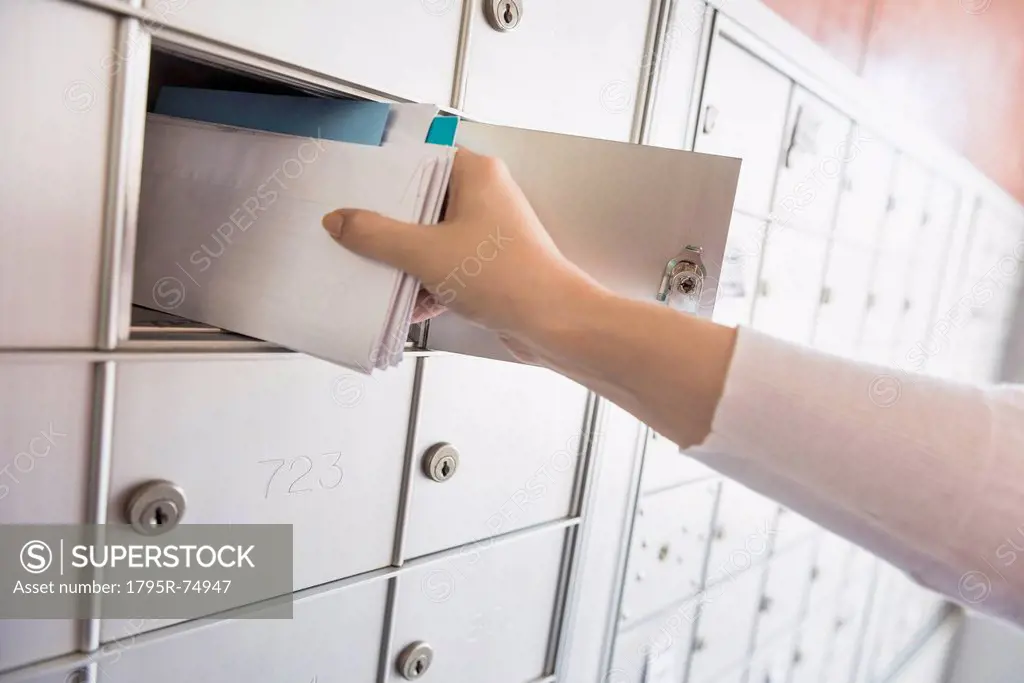 Woman taking letters from safety deposit box
