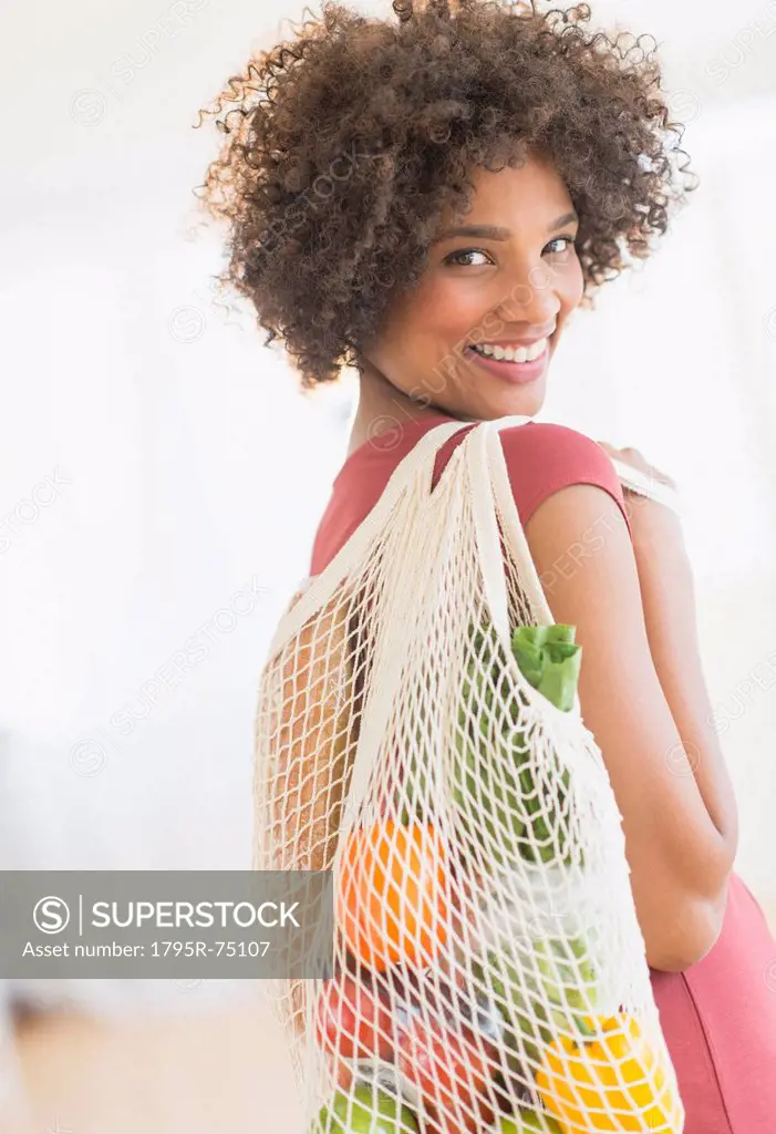 Portrait of woman carrying grocery bag